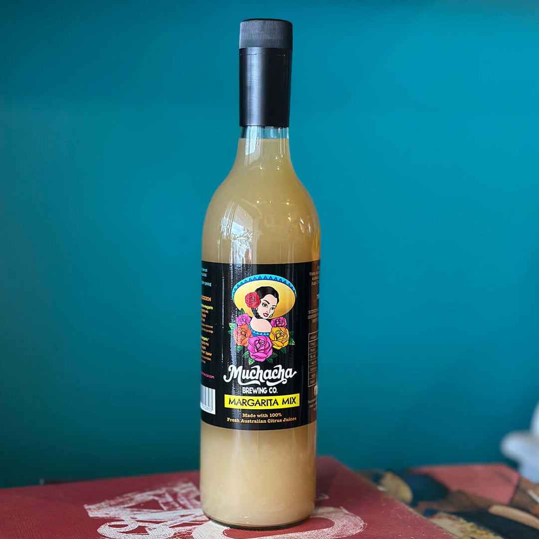 Bottle of Muchacha Margarita Mix with colorful label on a teal background