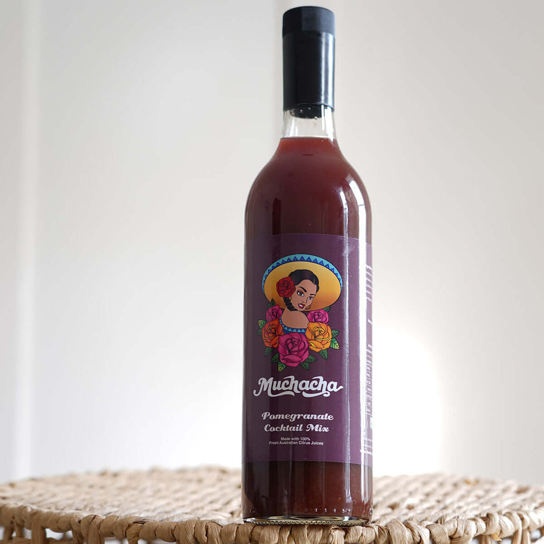 Bottle of Muchacha Pomegranate Cocktail Mix on a white background