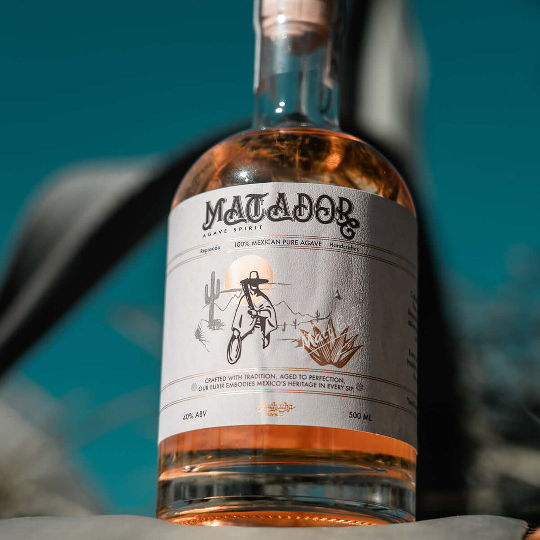 Bottle of Matador tequila with a label featuring a cowboy and desert landscape design.